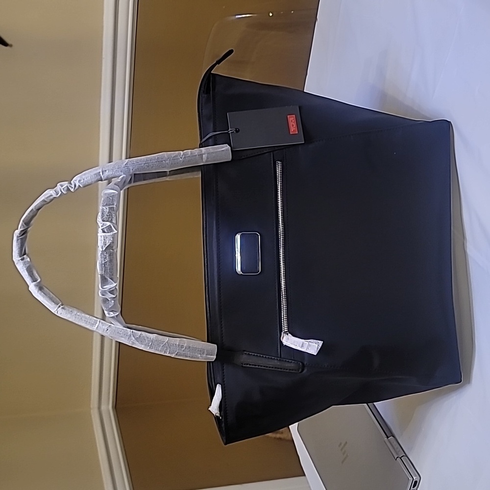 TUMI travel tote, black, 95% nylon with leather trim and straps